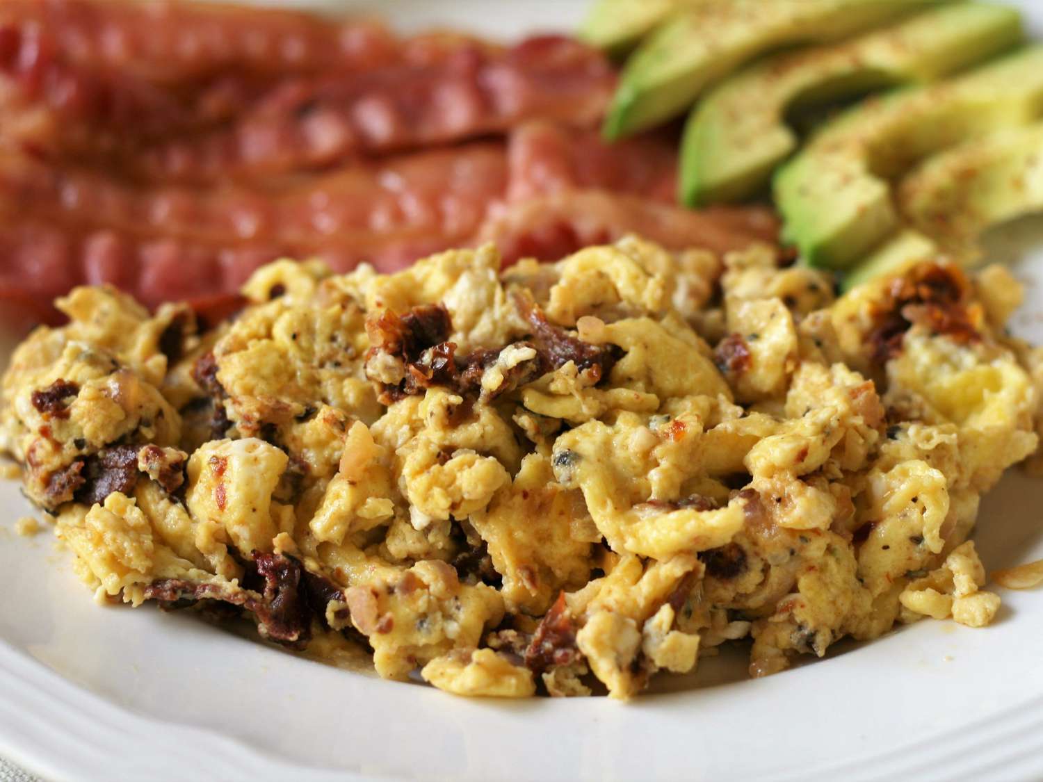 scrambled eggs with sundried tomato on plate